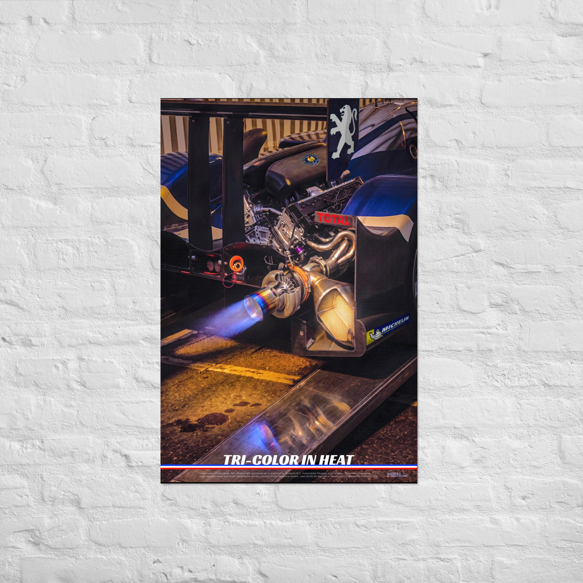 A vertical photographic art print featuring a close-up of a race car engine with a blue flame jet, labeled 'TRI-COLOR IN HEAT' at the bottom, shown against a plain white background.