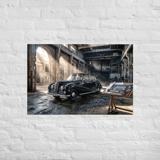 A rectangular wall art print showing a vintage black car inside a large industrial warehouse, mounted on a white painted brick wall.