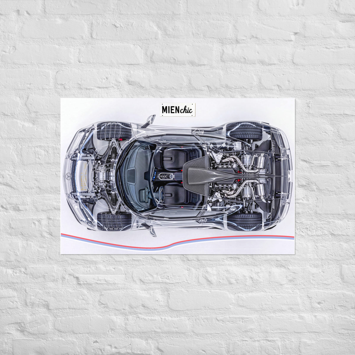 A rectangular wall art print showing a top-down cutaway view of a sports car with exposed engine components, mounted on a white brick wall. The print has a white background with a small MIEN chic logo at the top and a thin red and blue line near the bottom.